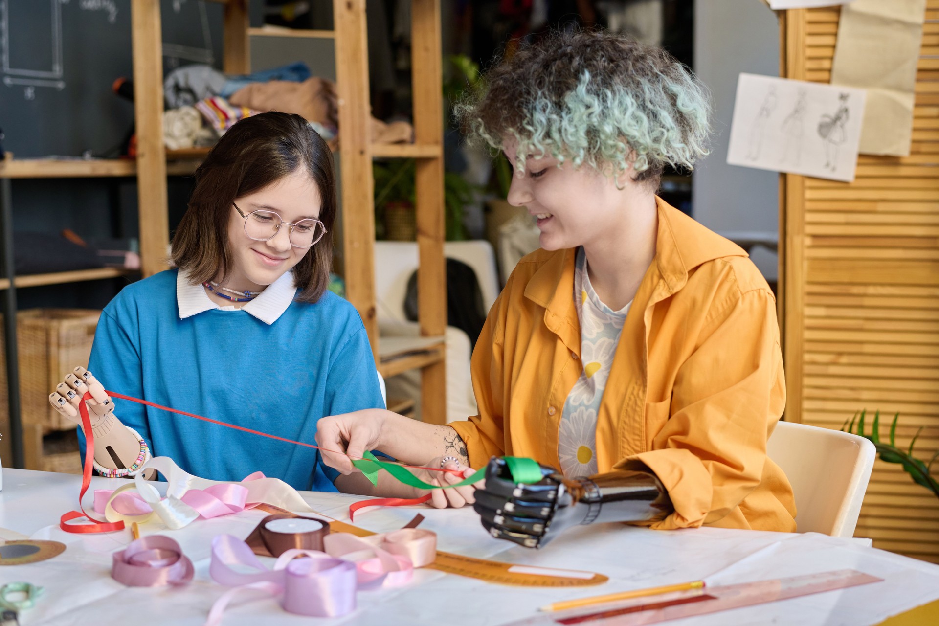 Two Teenage Girls with Prosthetic Hands in Sewing Class